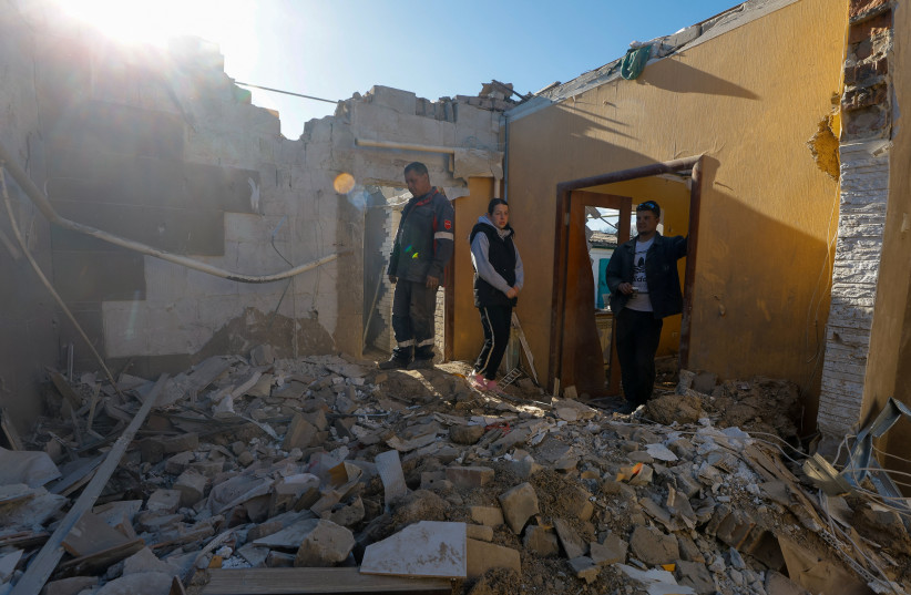 Local resident and house owner Alexander (didn't give his last name) and his relatives stand amid debris following a recent drone attack, which Russian-installed authorities called a Ukrainian military strike, in the course of the Russia-Ukraine conflict in the village of Stariy Krym.