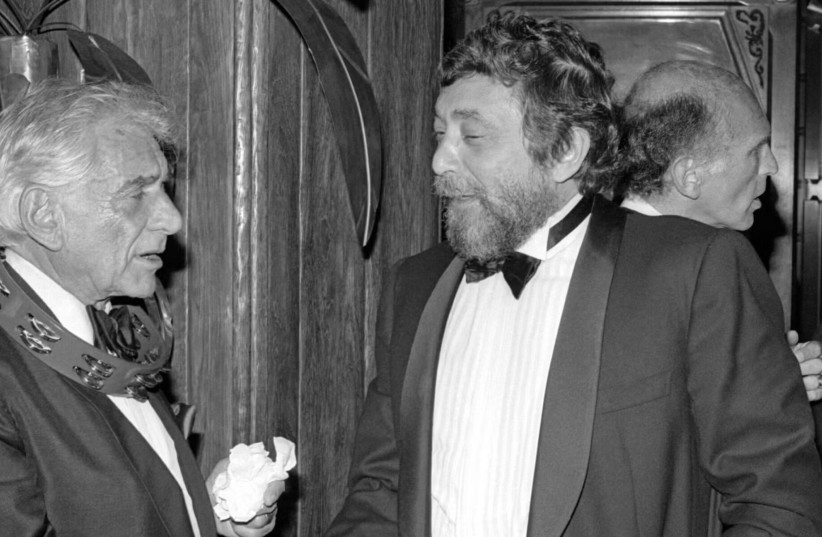 Conductor and composer Leonard Bernstein and American music industry executive Walter Yetnikoff talk and shake hands during the 27th Grammy Awards after party on Feb. 26, 1985 in Los Angeles.