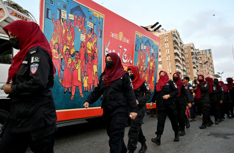 Women police personnel walk as part of security measures during a rally organised by women's rights group Aurat March on the occasion of Mother's Day in Karachi on May 10, 2026.