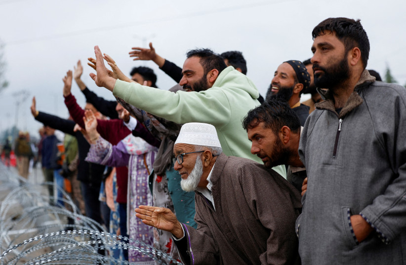 Relatives of Kashmiri hajj pilgrims wave goodbye as they depart for Mecca for the annual pilgrimage to the holiest place for Muslims, in Srinagar, Indian Kashmir, April 18, 2026.
