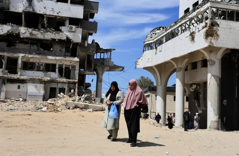 Unas mujeres palestinas pasan junto a edificios dañados durante la guerra en el Hospital Al-Shifa, en la ciudad de Gaza, Gaza, el 31 de marzo de 2026.