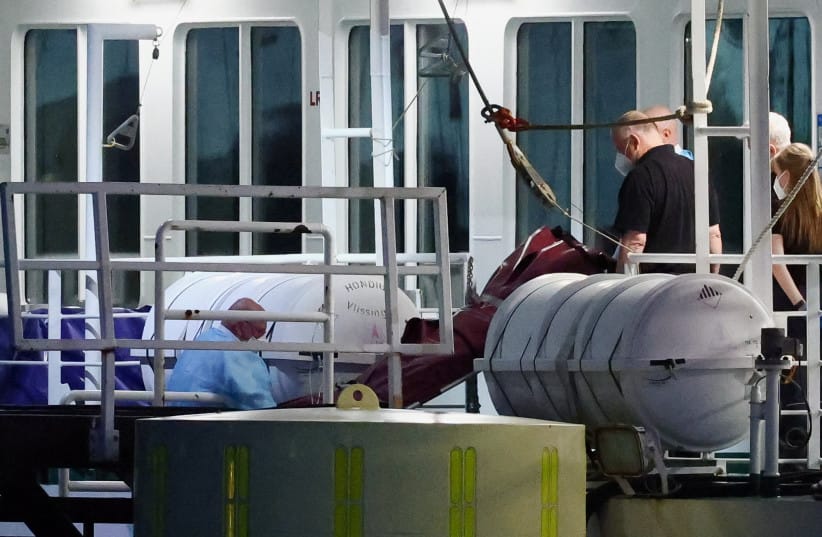 The body of a German woman who died is disembarked from the cruise ship MV Hondius, which was affected by a hantavirus outbreak, after the ship arrived at the Port of Rotterdam, where Dutch authorities are preparing quarantine arrangements, in Rotterdam, Netherlands, May 18, 2026.
