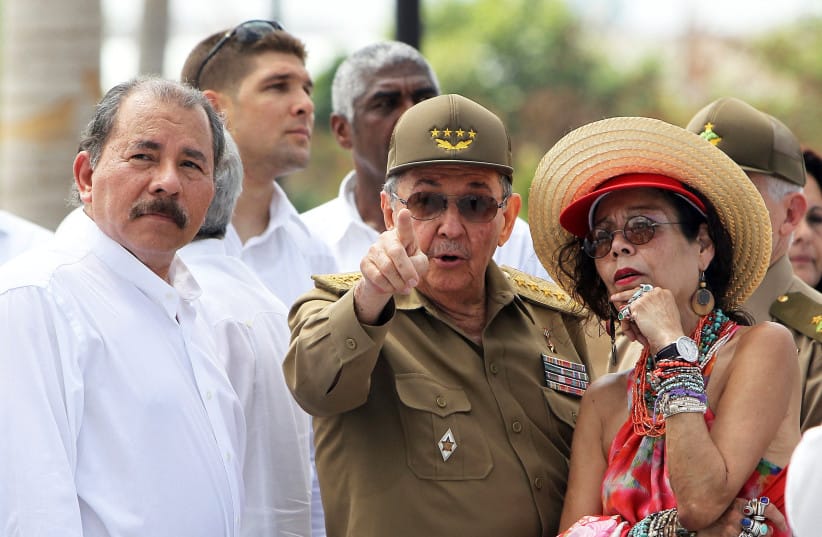 Cuba's President Raul Castro (C) talks to Nicaragua's President Daniel Ortega (L) and his wife Rosario Murillo during a wreath-laying ceremony at the mausoleum of 19th century Cuban independence hero Jose Marti in Santiago de Cuba, Cuba July 26, 2013.