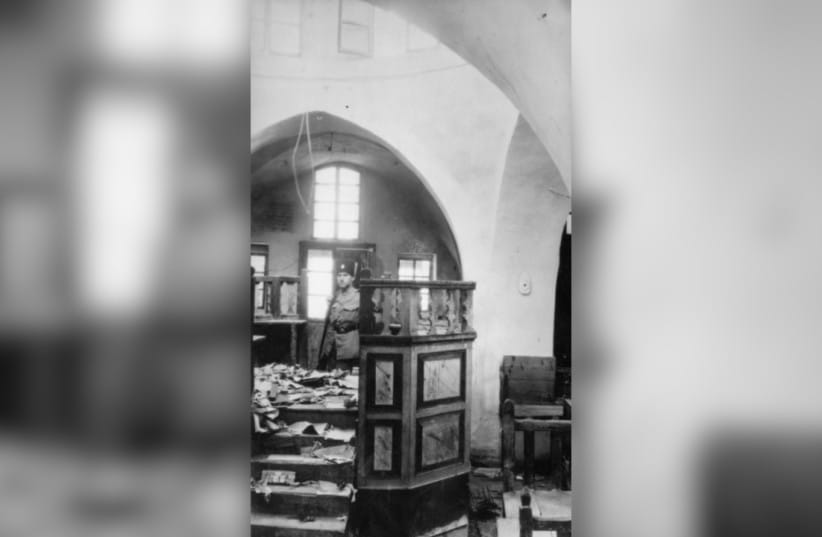 An officer of the Palestinian Police stands guard at a synagogue, which was damaged during the the Hebron massacre in Mandatory Palestine, 1929.