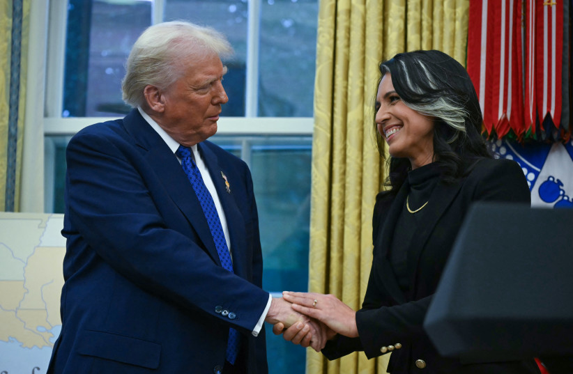 US President Donald Trump shakes hands with Tulsi Gabbard after she was sworn in as Director of National Intelligence (DNI) in the Oval Office of the White House in Washington, DC, on February 12, 2025.