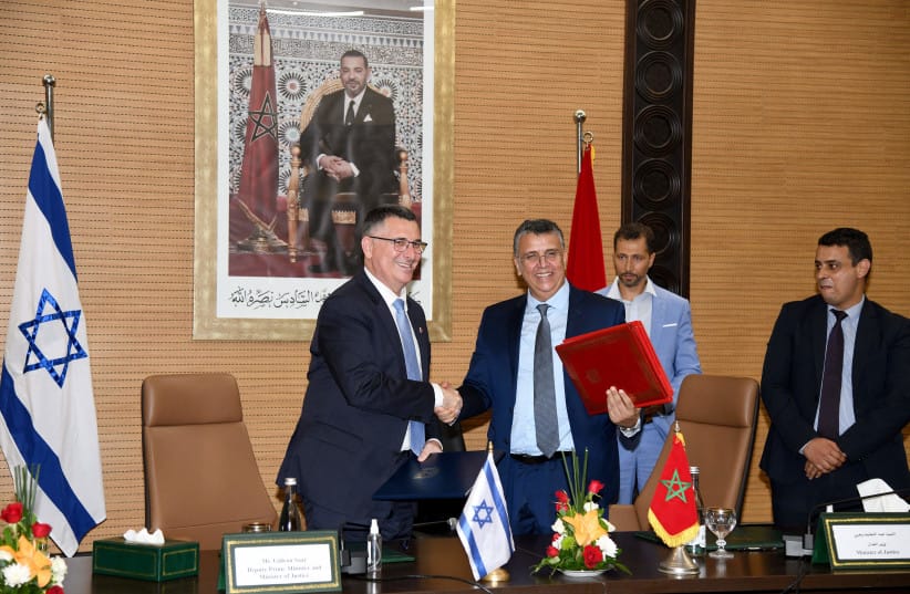 Moroccan Justice Minister Abdellatif Wehbe (R) and Israeli Justice Minister Gideon Saar (L), shake hands after signing an agreement in Rabat on July 26 , 2022.