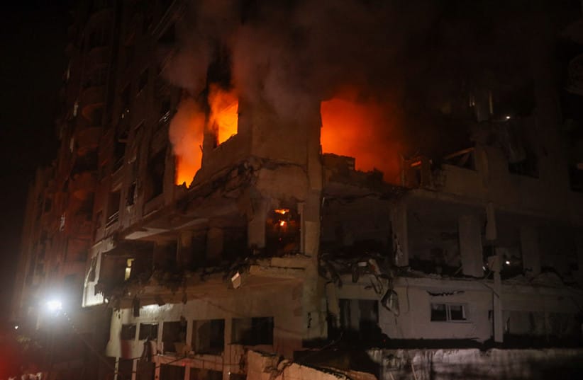 FIRE AND smoke billow from a damaged building following an Israeli airstrike in Gaza City, Gaza Strip, on May 15, 2026.