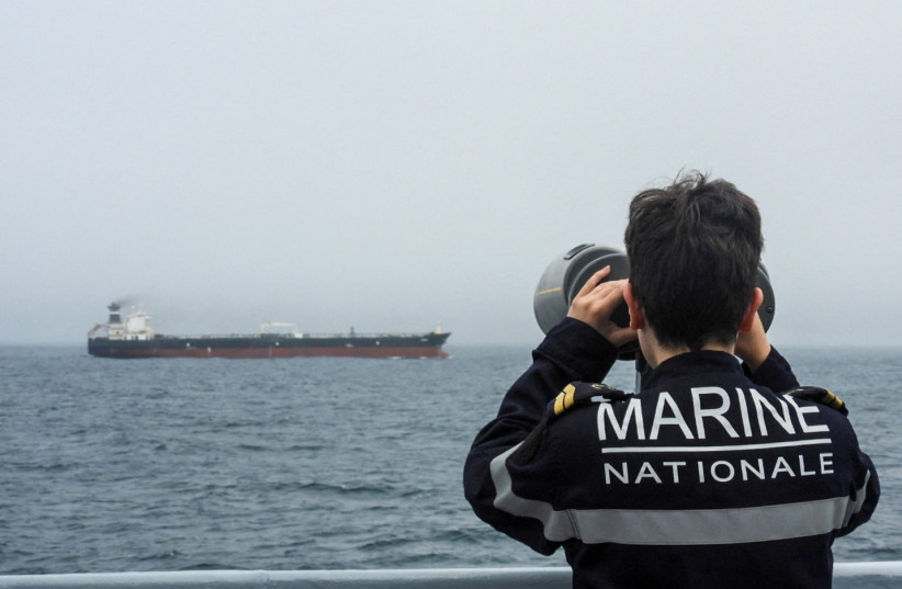 A French Navy personnel observes an oil tanker, subject to international sanctions and sailing from Russia, sailing in the Atlantic Ocean, in this handout obtained by Reuters on June 1, 2026.