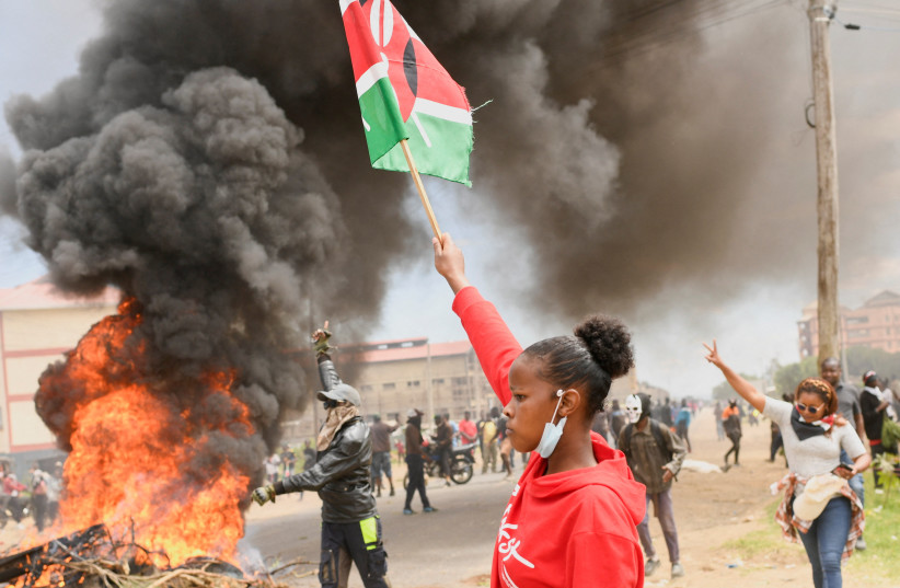 A demonstrator holds a Kenyan flag during a protest against a US-backed Ebola quarantine plan on the establishment of a 50-bed facility at a Kenyan air force base that was intended to host Americans exposed to Ebola, in Nanyuki town, in Laikipia County, Kenya, June 1, 2026.