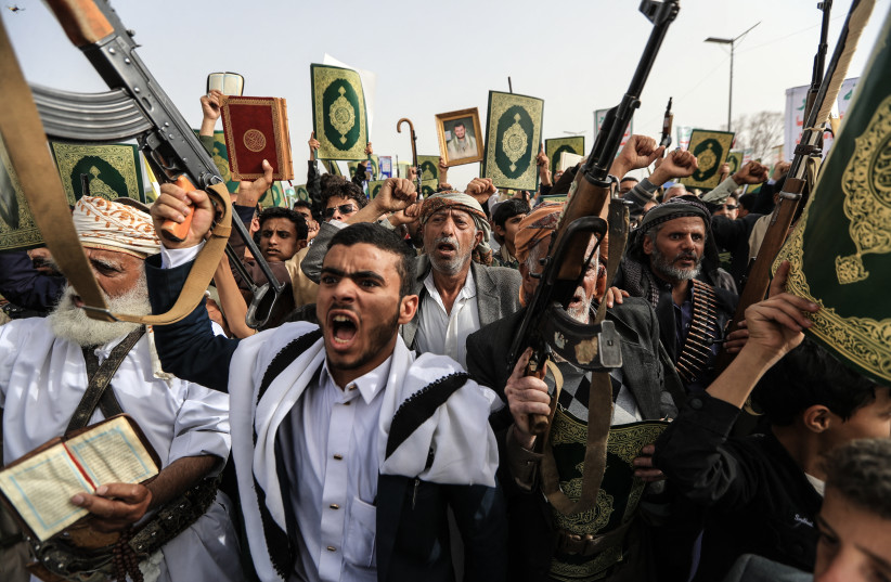 Supporters of the Iran-backed Houthi movement brandish weapons and copies of the Quran as they rally in solidarity with Lebanon in Sanaa on May 18, 2026.