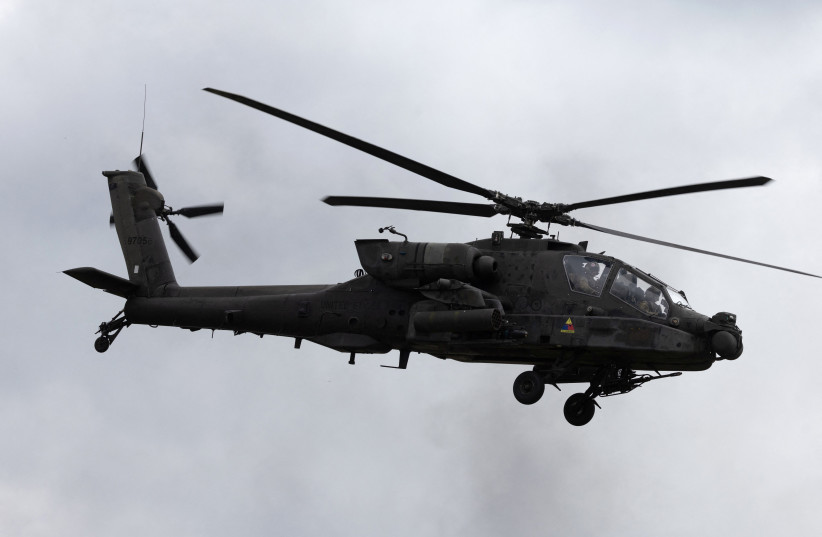 A US Army AH-64D Apache helicopter hovers flies during military exercises of Poland and NATO allied countries in Orzysz, northwestern Poland, on September 17, 2025.