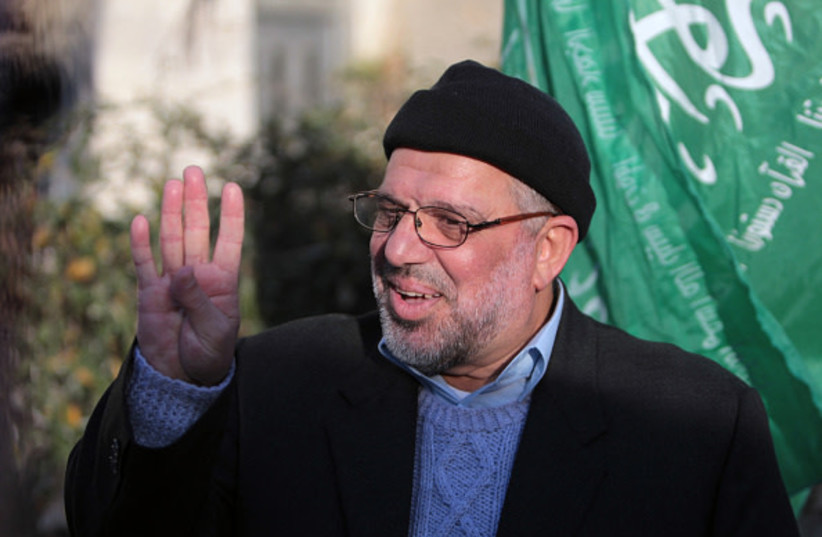 Hams co-founder Hassan Yousef flashes the four finger ''Rabaa'' sign,following his release from Israel's Ofer prison, near the West Bank city of Ramallah on January 19, 2014 after spending 28 months in prison.