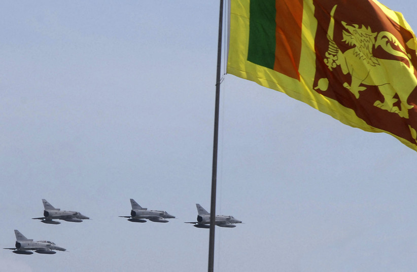 Sri Lanka air force IAI Kfir fighter jets fly past a national flag during the National Victory Ceremony in Colombo June 3, 2009. (credit: REUTERS/Stringer