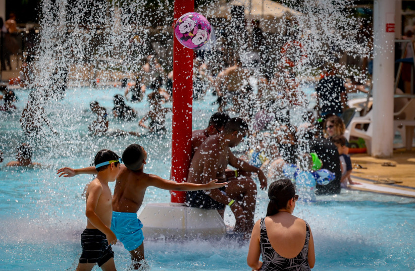 People enjoy the water at a water park during the summer holiday, in Modi'in.