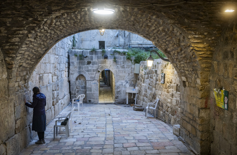 A Jewish woman prays at the Little Western Wall in Jerusalem’s Old City, February 18, 2026.