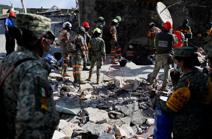 Rescue personnel work as rescue operations continue after earthquakes hit the country, in La Guaira, Venezuela, June 27, 2026.