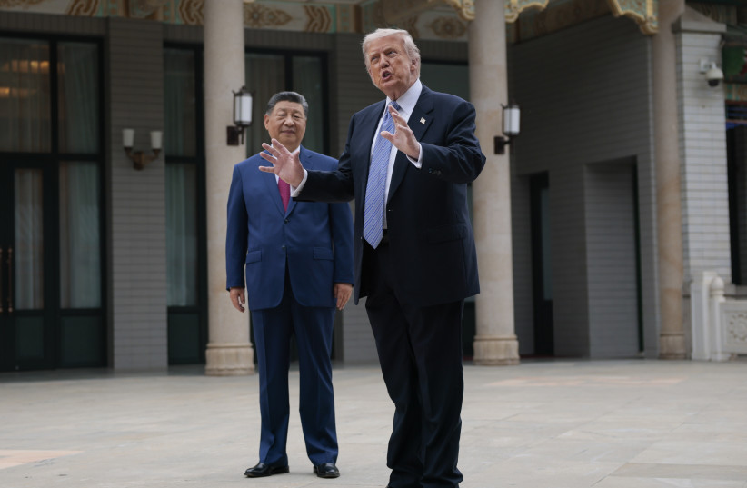 U.S. President Donald Trump gestures as Chinese President Xi Jinping looks on during a tour of Zhongnanhai Garden on May 15, 2026 in Beijing, China.