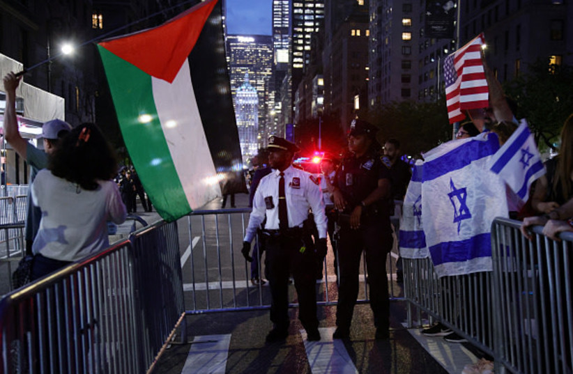 Pro-Palestinian activists wave a Palestinian flag as they take part in the ''Autonomous Noise Demonstration for Gaza'', across from supporters of Israel