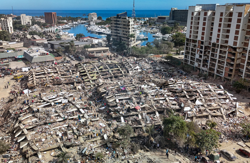 This aerial view shows destroyed buildings in Caraballeda, La Guaira state, Venezuela, on June 28, 2026, following earthquakes. Thousands of rescuers, relatives and volunteers dig day and night through mounds of concrete to find survivors of the earthquakes that struck Venezuela more than three days