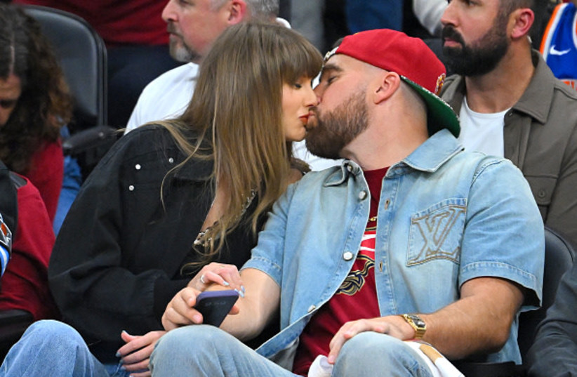 CLEVELAND, OHIO - MAY 23: (L-R) Singer Taylor Swift and Travis Kelce of the Kansas City Chiefs kiss during Game Three between the New York Knicks and the Cleveland Cavaliers in the NBA Eastern Conference Finals at Rocket Arena on May 23, 2026 in Cleveland, Ohio.