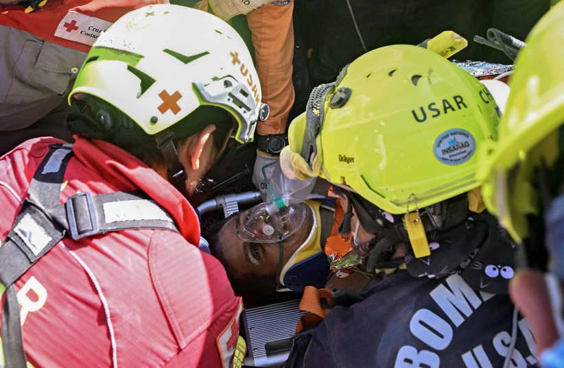 An international rescue team assists Hernan Gil, a survivor of Venezuela's twin earthquakes, in Catia La Mar, La Guaira State, Venezuela on July 2, 2026, eight days after the quake.