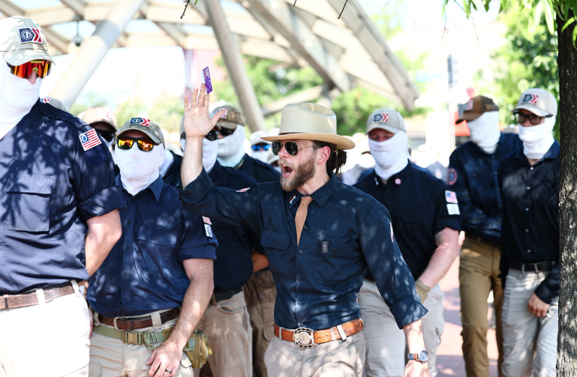 Founder of the white supremacist group Patriot Front Thomas Rousseau (C) and fellow members gather at Eastern Market metro station on July 04, 2026 in Washington, DC.