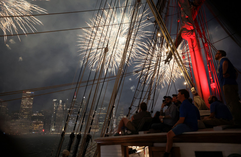 People watch Macy's Fourth of July fireworks as the United States celebrates its 250th anniversary, from a ship at Brooklyn Bridge Marina, in New York City, US, July 4, 2026 (credit: REUTERS/Heather Khalifa)