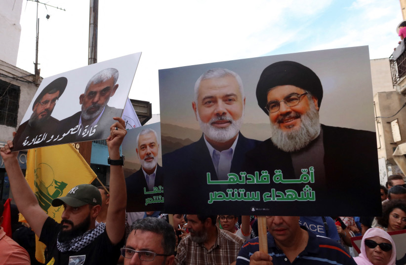 Demonstrators carry pictures of Hamas leaders Ismail Haniyeh and Yahya Sinwar, and Hezbollah leader Sayyed Hassan Nasrallah during a protest in support of Lebanon and Gaza, in Tunis, Tunisia October 7, 2024