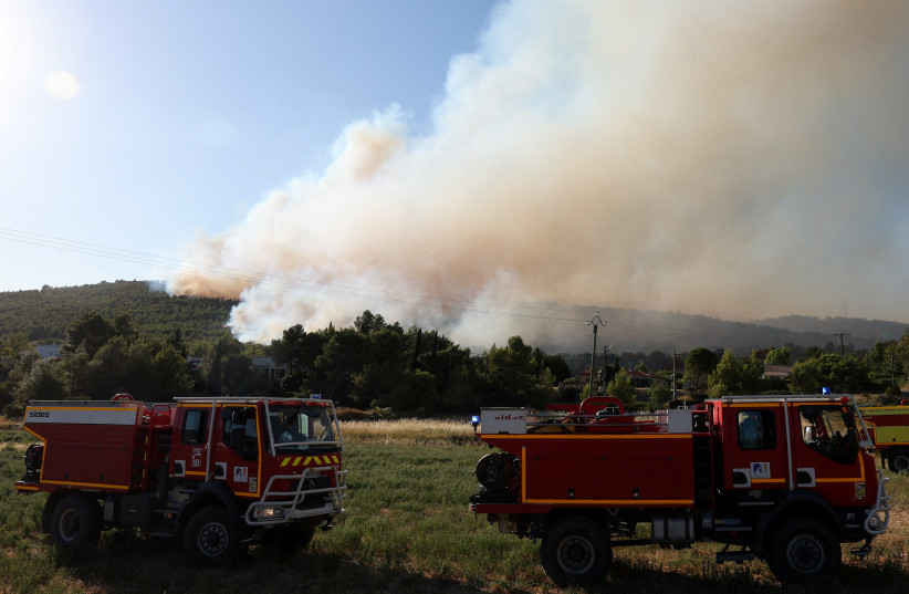 Firefighting vehicles as a wildfire burns in Pouzols-Minervois near Narbonne, France, July 2, 2026.