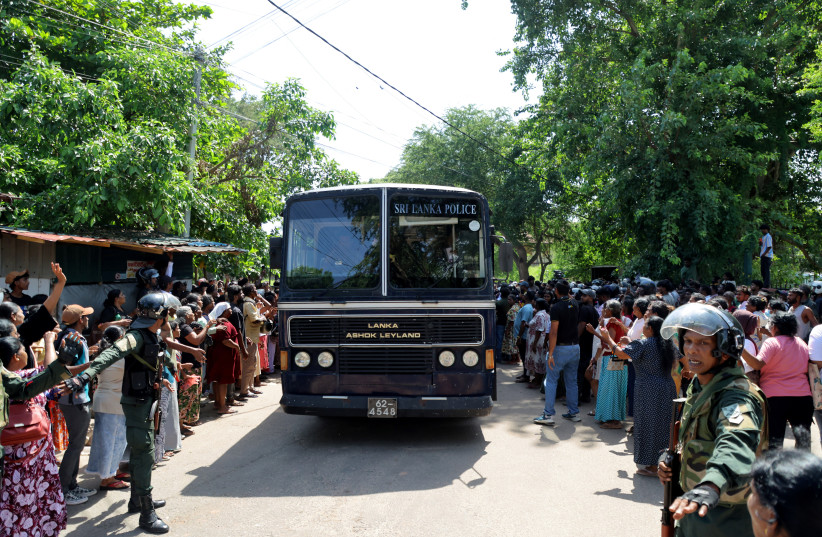 Members of security forces make way for a bus carrying prisoners to be transferred to another prison following clashes between two groups of inmates at Negombo Prison, in the coastal town of Negombo, Sri Lanka, July 6, 2026.
