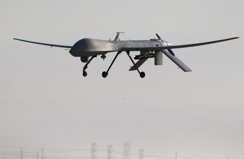A US Air Force MQ-1B Predator unmanned aerial vehicle (UAV), carrying a Hellfire missile lands at a secret air base after flying a mission in the Persian Gulf region on January 7, 2016.