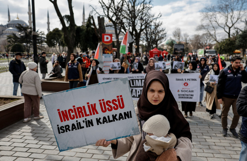 A woman holds a placard that reads ''Incirlik Air Base shield of Israel'' during a march after late Iran's Supreme Leader Ayatollah Ali Khamenei was killed in Israeli and US strikes, in Istanbul, Turkey, March 1, 2026.