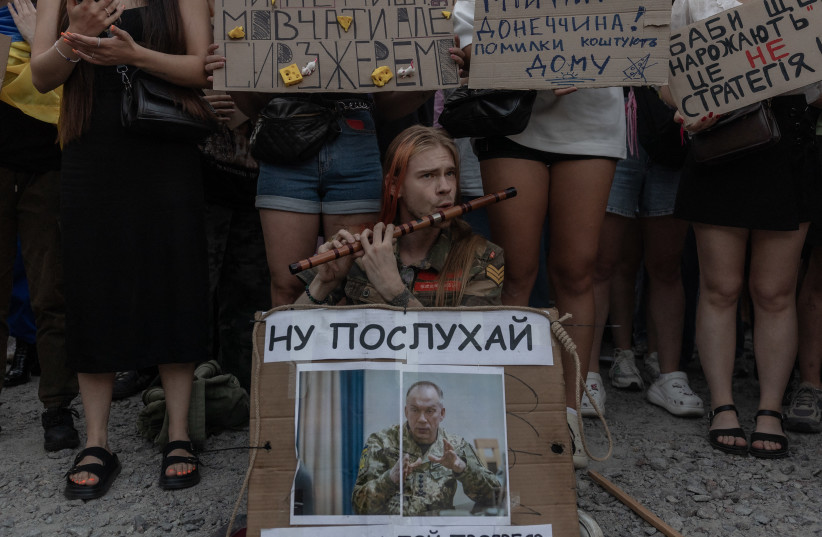 Protesters attend a demonstration against Ukraine's President's decision to dismiss Ukraine's Defence Minister Mykhailo Fedorov, and demanding the dismissal of Ukraine's army chief Oleksandr Syrskyi, in Kyiv on July 18, 2026.