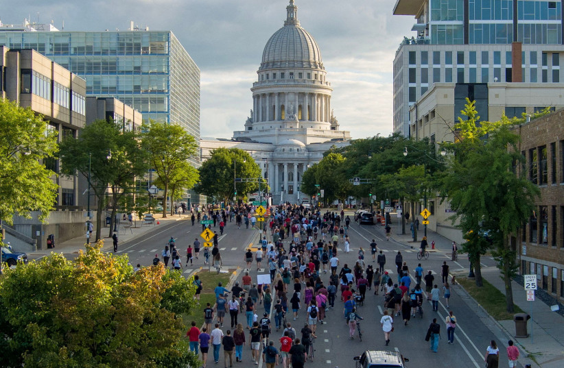 People march in protest to the Wisconsin State Capitol in response to a Madison police officer shooting and killing a man who police reported to be carrying a knife on the city's near east side, in Madison, Wisconsin July 22, 2026.