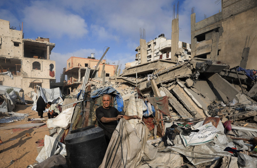 A Palestinian man inspects the site of Wednesday's Israeli strike on a house whose residents were pre-warned by the Israeli military to evacuate, in Gaza City, July 30, 2026.