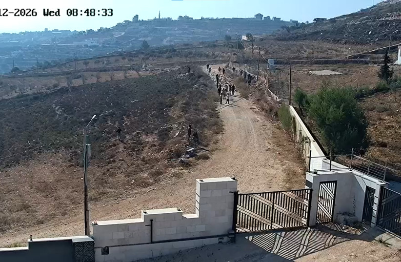 Israeli settler extremists throw stones at a dirt road at the Palestinian village of Kusra, in the West Bank, in an attempt to block the movement of Palestinians and Israeli forces, August 12, 2026