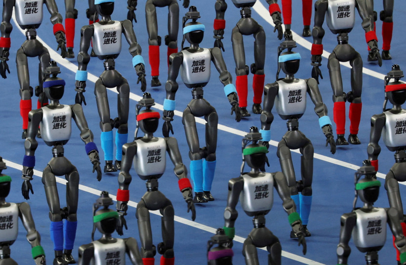 Booster Robotics humanoid robots walk in formation during the opening ceremony for the second World Humanoid Robot Games at the National Speed Skating Oval in Beijing, China August 22, 2026.
