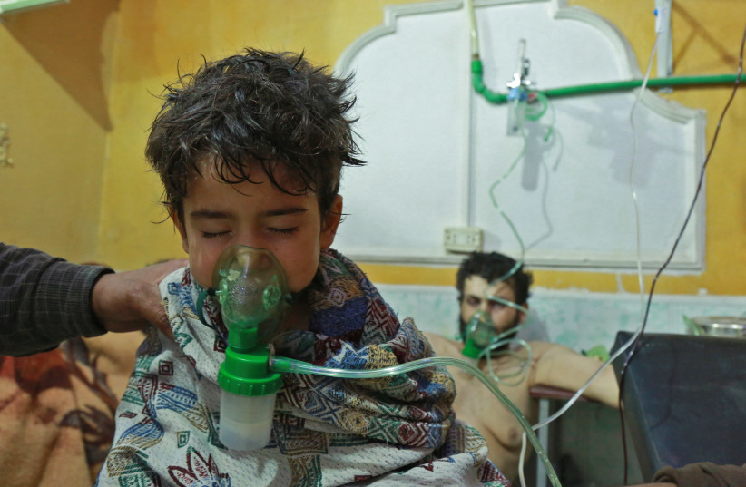 Syrian children and adults receive treatment for a suspected chemical attack at a makeshift clinic on the rebel-held village of al-Shifuniyah in the Eastern Ghouta region on the outskirts of the capital Damascus late on February 25, 2018.