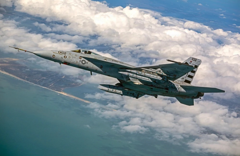 Four AIM-424 Long Range Air-to-Air Missiles (LRAAM) are loaded on an F/A-18E Super Hornet for a test event.