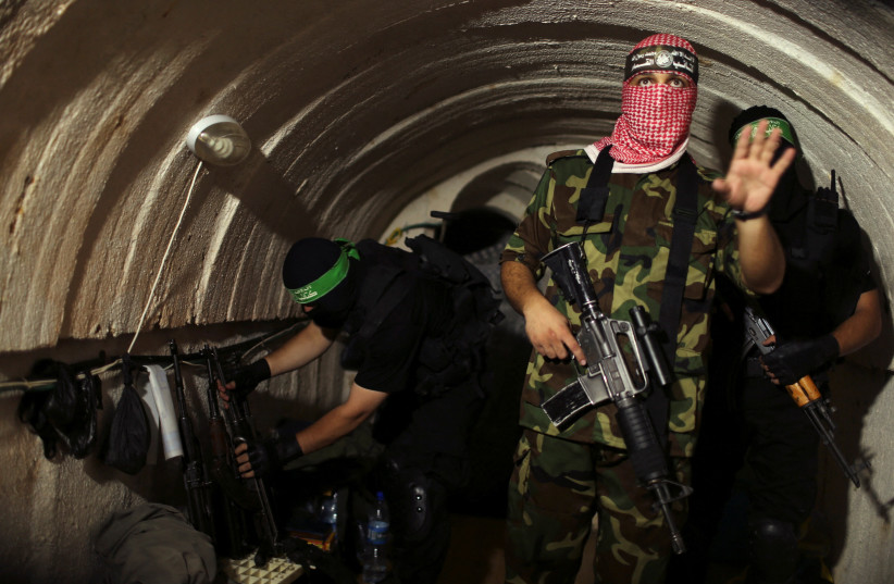 A terrorist from the Izz el-Deen al-Qassam Brigades, the armed wing of the Hamas movement, gestures inside an underground tunnel in Gaza August 18, 2014