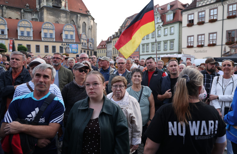 Supporters of the far-right Alternative for Germany (AfD) gather to hear AfD lead candidate Ulrich Siegmund speak at an AfD campaign rally prior to state elections in Saxony-Anhalt on August 24, 2026 in Naumburg, Germany.