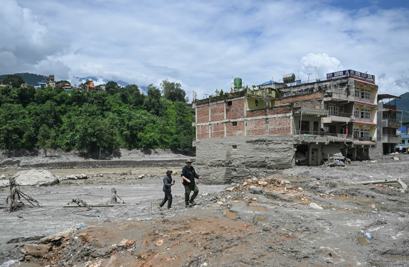 Members of the Harel 669 search and rescue team inspect the affected area at the Trishuli Center in the aftermath of flash floods in Nepal's Nuwakot district on August 30, 2026.