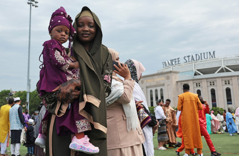 Muslim men, women, and children participate in a mass Eid al-Adha prayer in a park across the street from Yankee Stadium on May 27, 2026, in the Bronx borough of New York City.