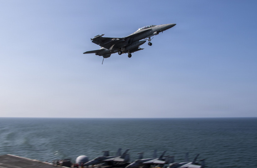 In this handout photo provided by the US Navy, An F/A-18F Super Hornet, attached to Strike Fighter Squadron (VFA) 41, flies over the flight deck of Nimitz-class aircraft carrier USS Abraham Lincoln (CVN 72) in support of Operation Epic Fury on March 6, 2026 in the Mediterranean Sea; illustrative