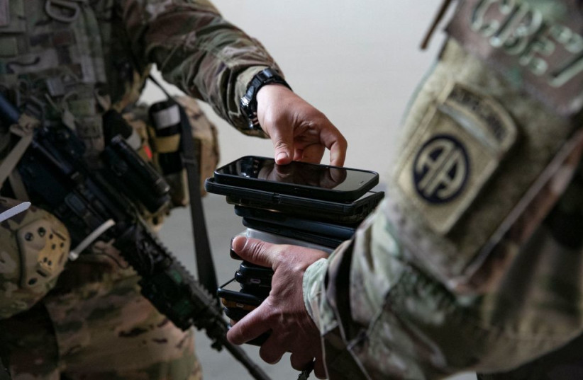 Soldiers of the 82nd Airborne Division surrender their cell phones before deploying to Europe, February 14, 2021, in Fort Bragg, North Carolina.