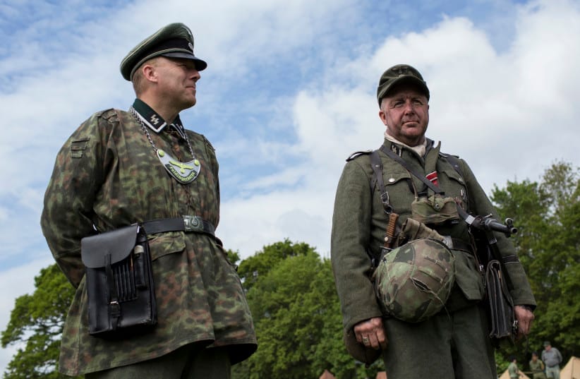 Portraying the SS Panzer Division Leibstanarte SS Adolf Hitler, members of The Second Battle Group watch as troops parade as they took part in the Overlord Military Spectacular, a gathering of military re-enactors on May 24, 2015; Illustrative.