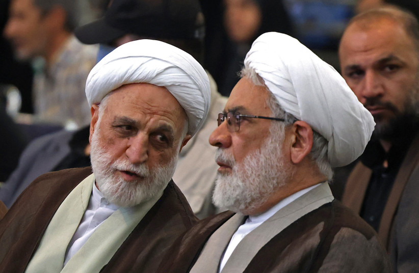 Iran's Judiciary Chief Gholamhossein Mohseni Ejei (L) attends a gathering at the Imam Khomeini Mosque (Mosalla) to commemorate those killed in former wars and also those killed during the latest US-Israel led war, in Tehran on May 24, 2026.