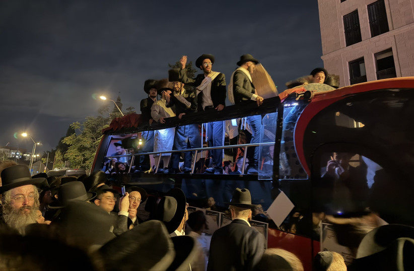 Ultra-Orthodox (haredi) protesters hold signs at a massive anti-draft march in Jerusalem, September 29, 2026.