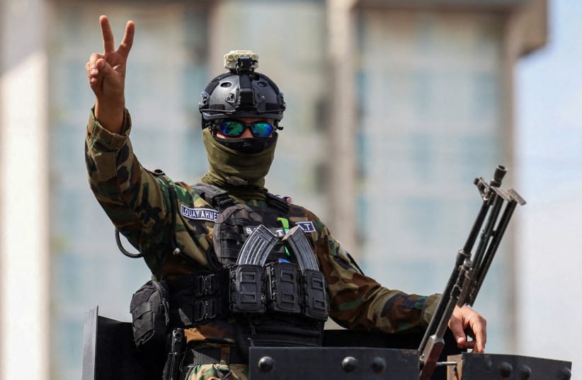 A member of the Iraqi security forces gestures as they drive in a convoy through the city as they celebrate the withdrawal of US-led coalition forces from Iraq, ending a military presence that began after the 2003 US-led invasion, in Baghdad, Iraq, September 30, 2026.