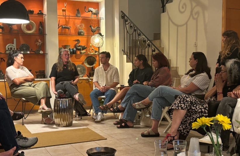 A Salon Otef participant shares her personal story with guests gathered in a private home.